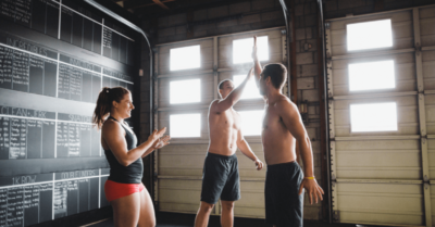 three people celebrating in a gym